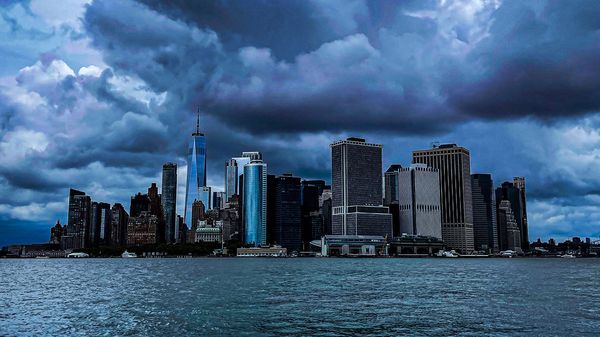 A dark and dreary New York City with ominous storm clouds