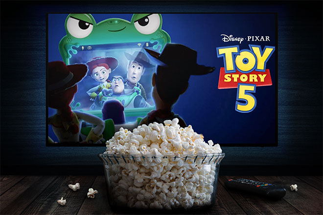 A bowl of popcorn in front of a screen showing "Toy Story 5."