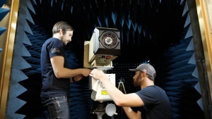two men work on mechanical device
