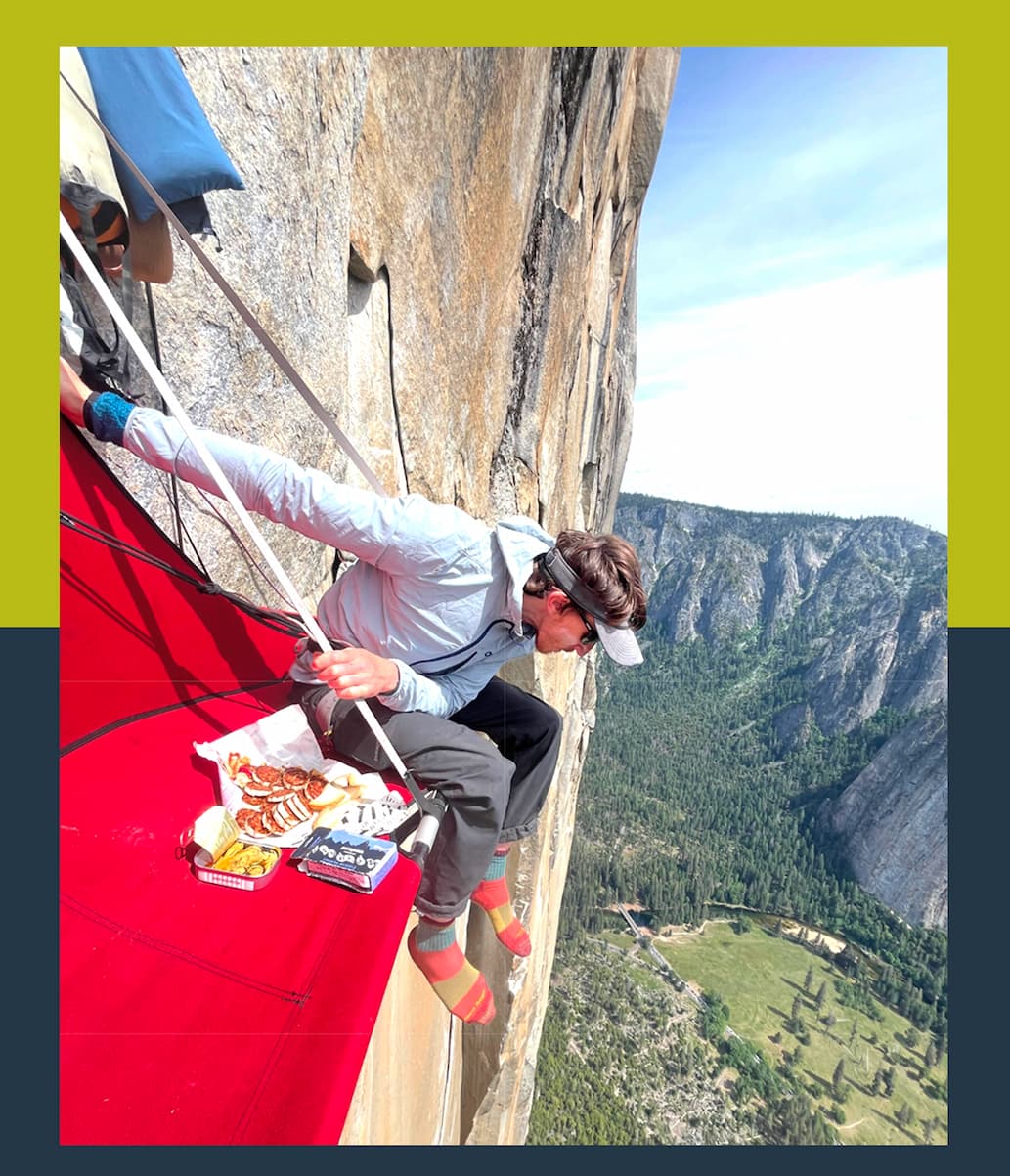 Tyler Karow resting with tinned fish and snacks on El Cap