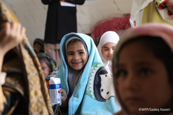 A student in Afghanistan receiving WFP school meal. 