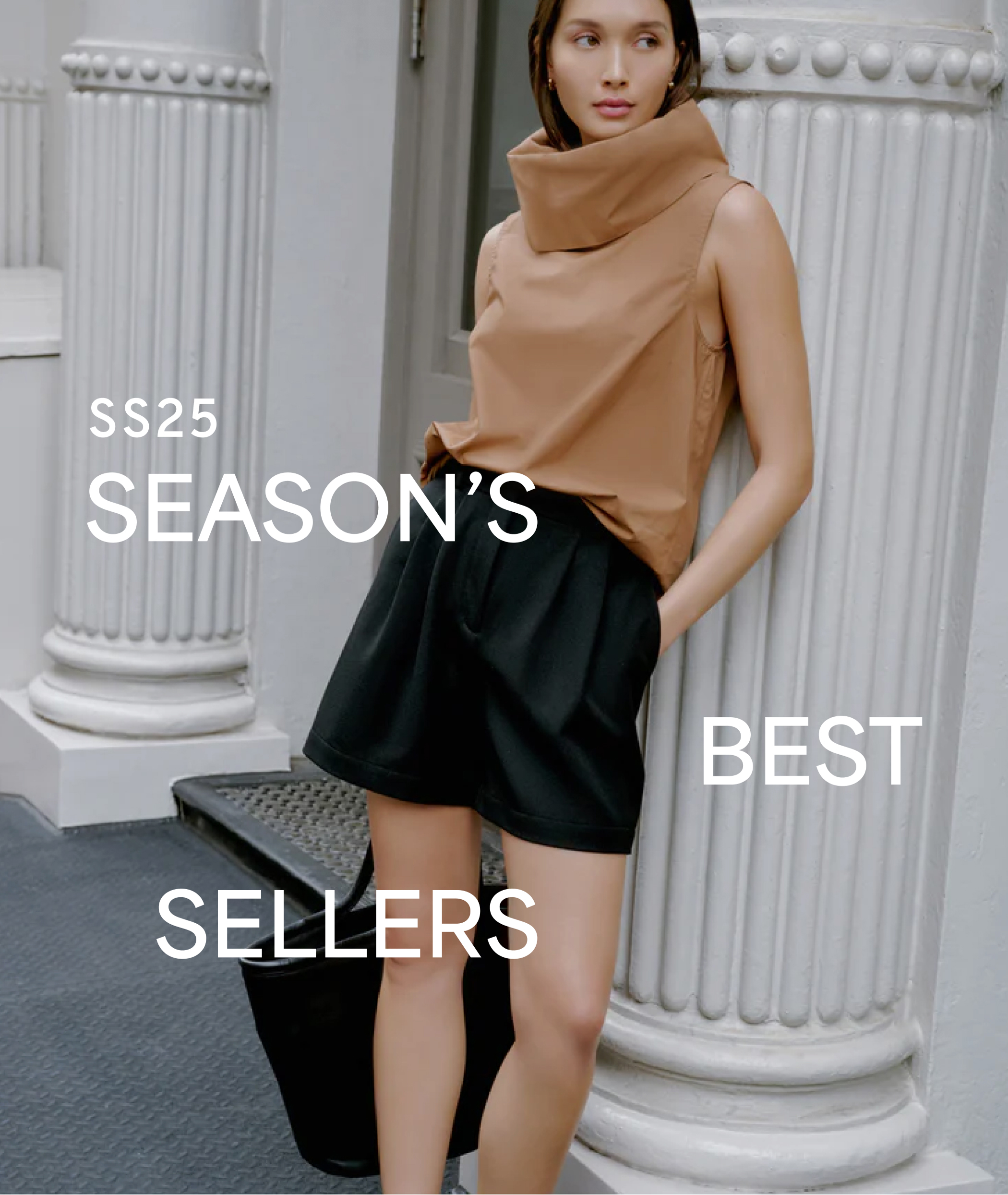 Street-style shot with “SS25 SEASON'S BEST SELLERS” text. Yada in Marcy Sleeveless Top, black tailored shorts, quilted slides, and a black tote by white columns.