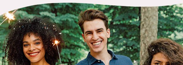 People smiling and holding sparklers