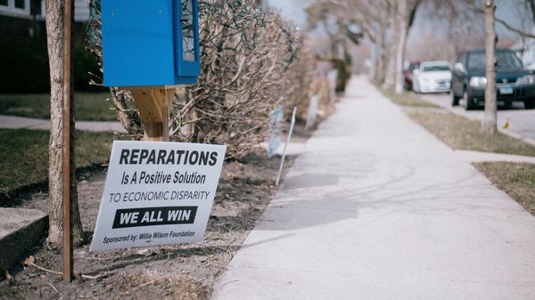 A sign in Evanston reads 'Reparations is a positive solution to economic disparity. We all win', Illinois, USA.