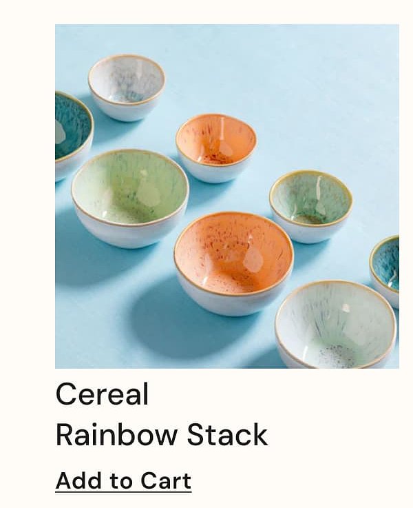 Colorful ceramic bowls in various sizes arranged on a light blue background.