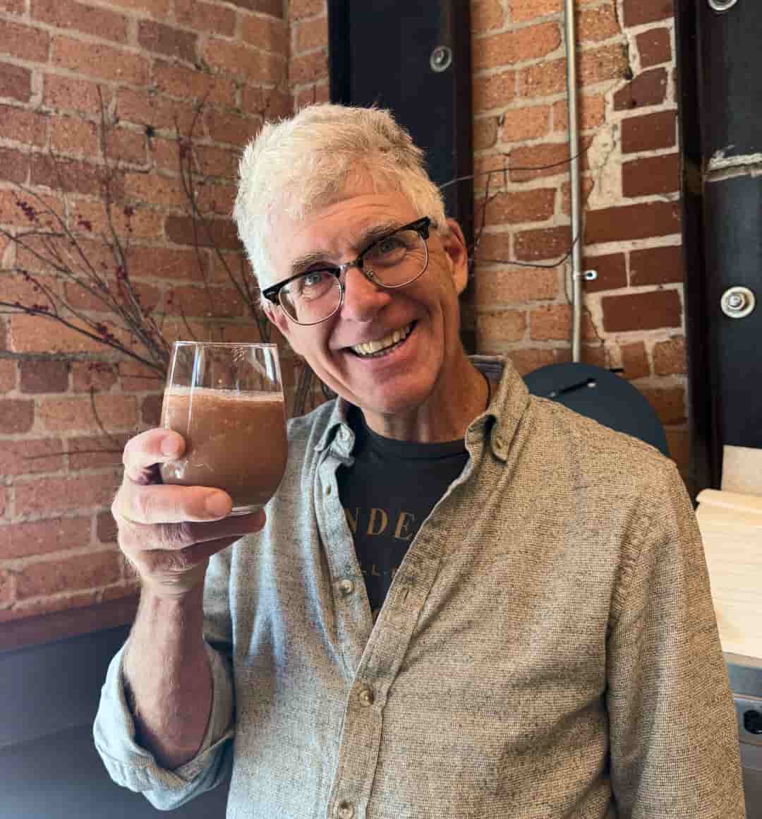 Stephen holds up a glass of his Simple Frozen Hot Chocolate.