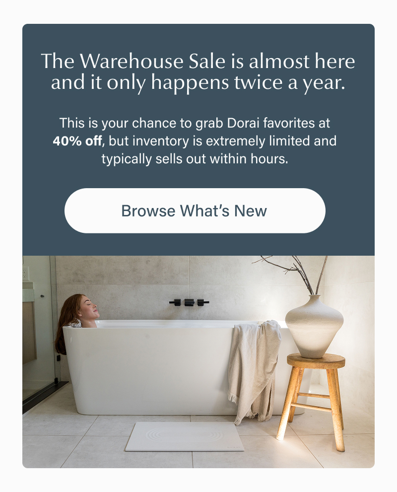 Lifestyle image of a woman soaking in a bathtub with a stone Dorai bath mat on the floor, with text explaining the warehouse sale is coming soon, happens twice a year, offers 40% off, and usually sells out within hours.