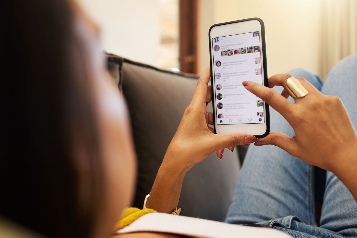 Woman on the couch scrolling on social media
