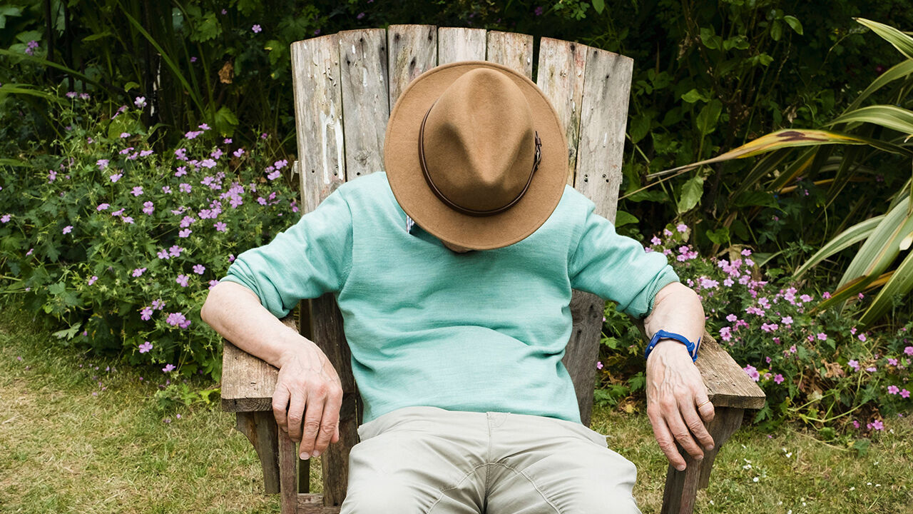 Man asleep in a garden chair. 