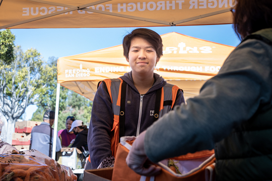 A volunteer at a food distribution event in San Diego, CA.