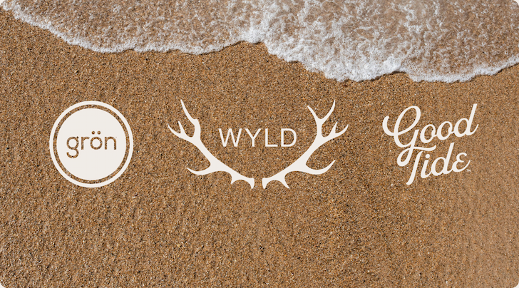 Grön, Wyld, and Good Tide logos on sandy beach