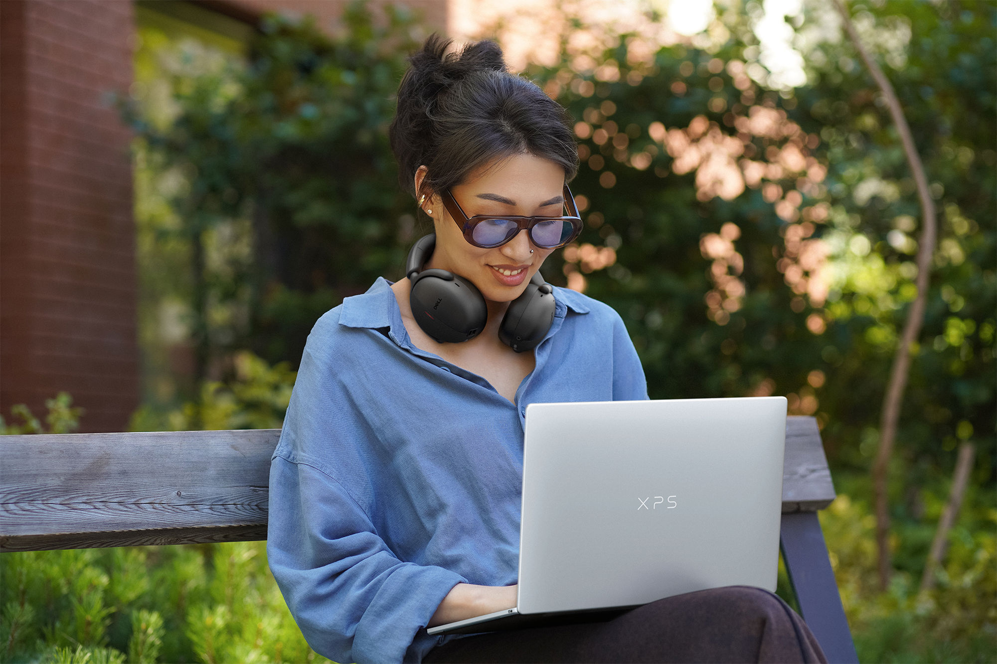 Woman sitting at table using laptop.