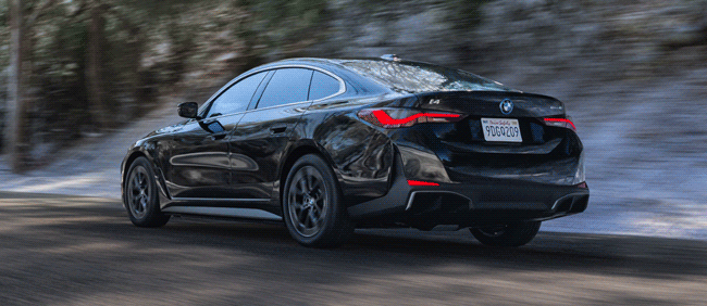 Four frames of BMW i4 driving on road