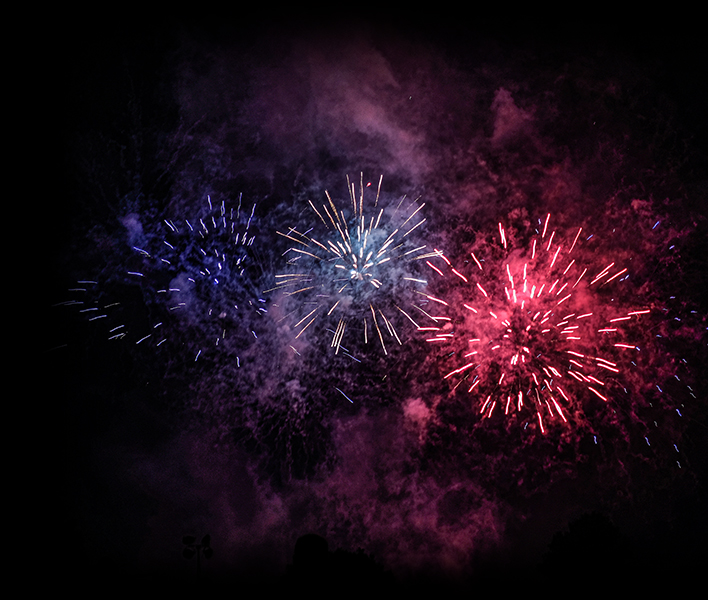 Fireworks exploding in the night sky.