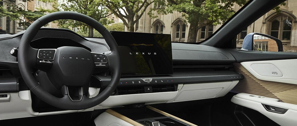 A shot of the cabin of the Lexus ES shows the steering wheel, dash and interior styling. Explore the ES.