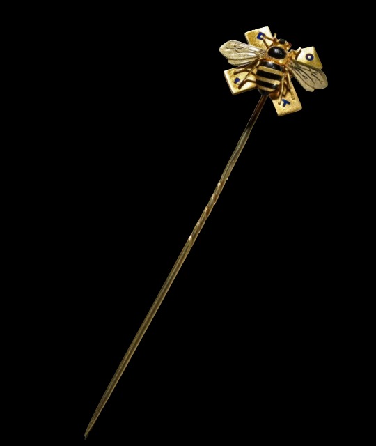 Enamelled gold cravat-pin.