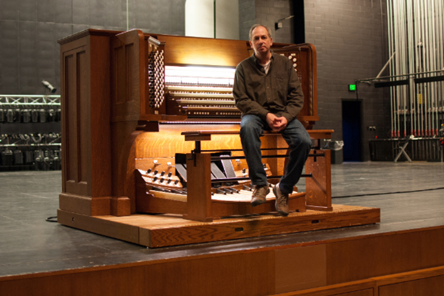 Steve Panizza sitting in front of the organ.