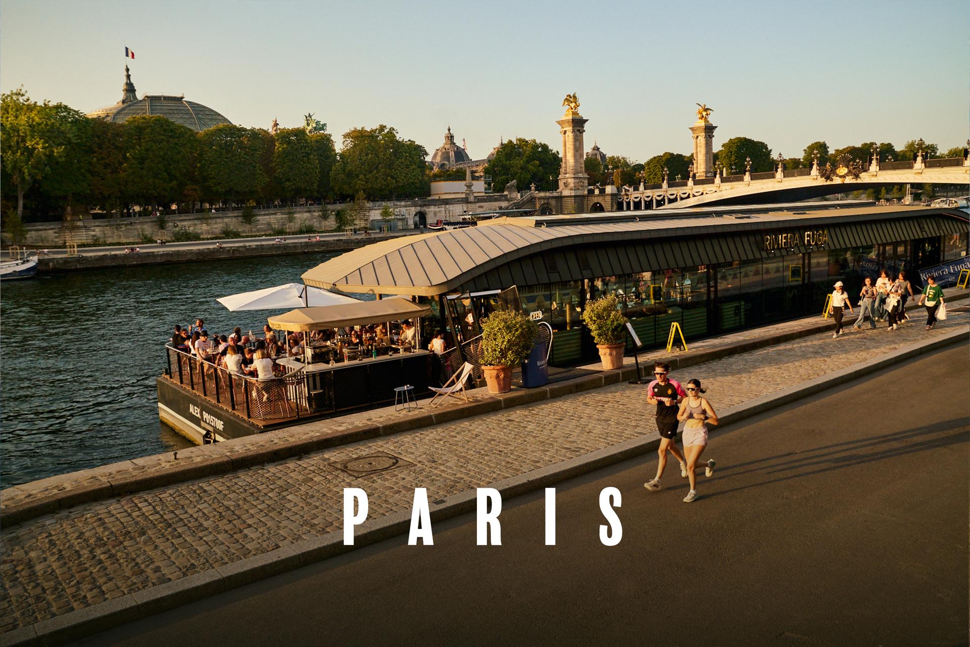 Joggers along the Seine in Paris at sunset