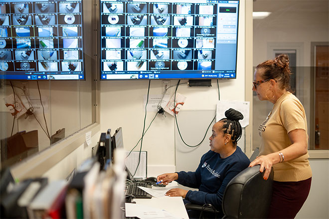 Stephanie Hollister and a nurse look at scans of a brain at the HUP-Cedar crisis response center.