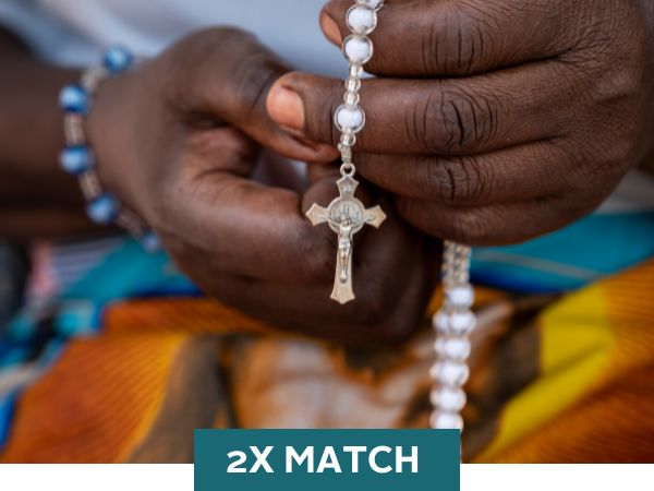 Image description: a hand holds a Rosary with a '2X Match' graphic