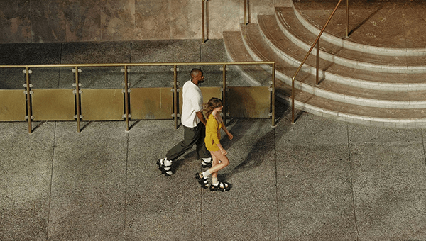 A couple walking on a side walk wearing Moonwalkers.