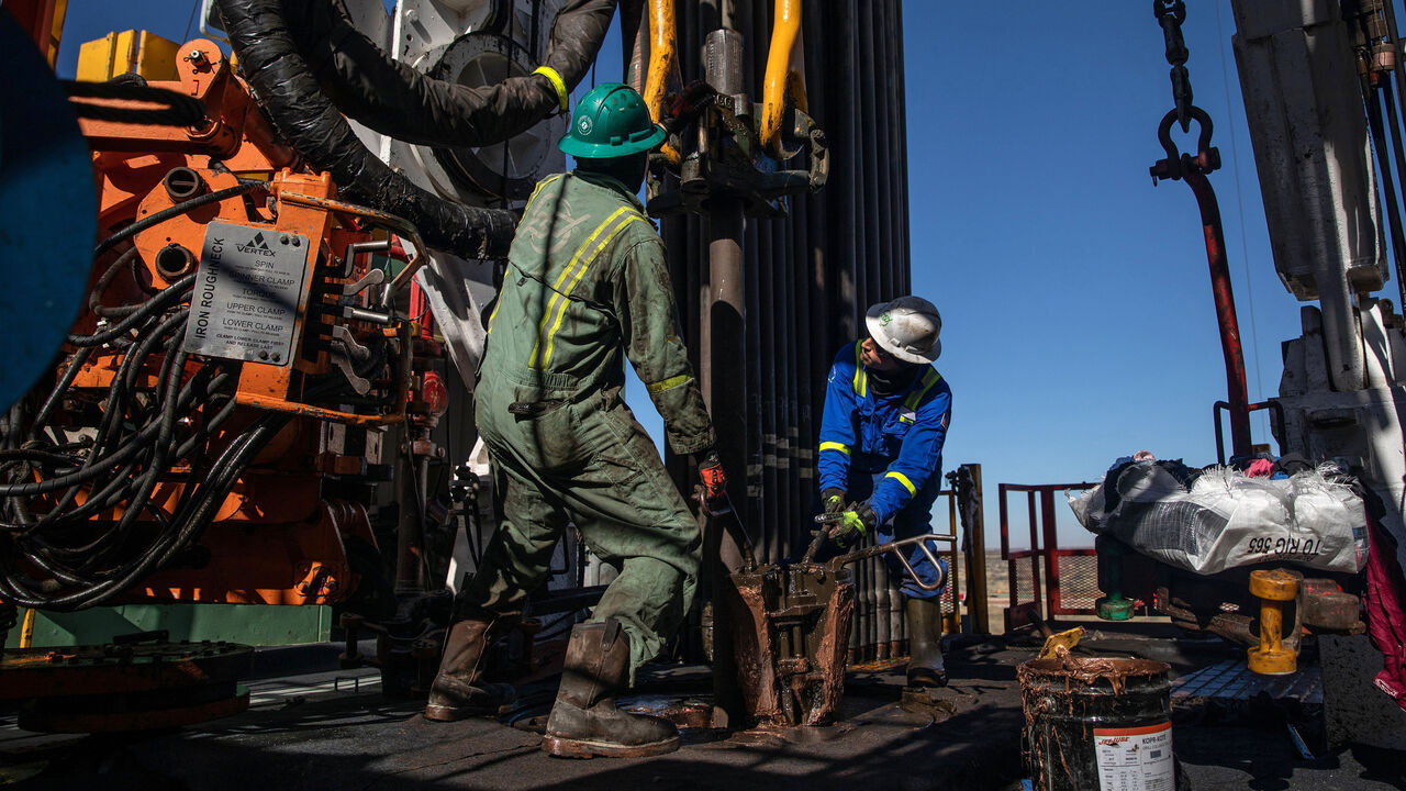 Floorhands work on a drilling rig contracted to Shell in the Delaware Basin, near Wink, Texas.