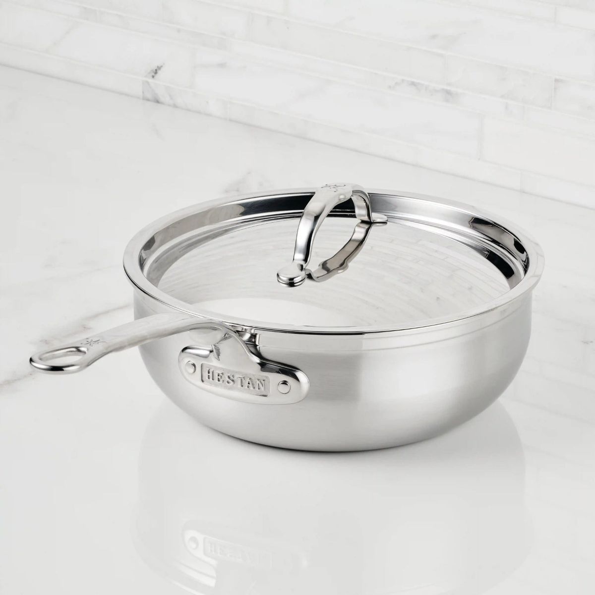 IMG: Brushed Clad Stainless Steel Essential Pan with Lid on marble countertop