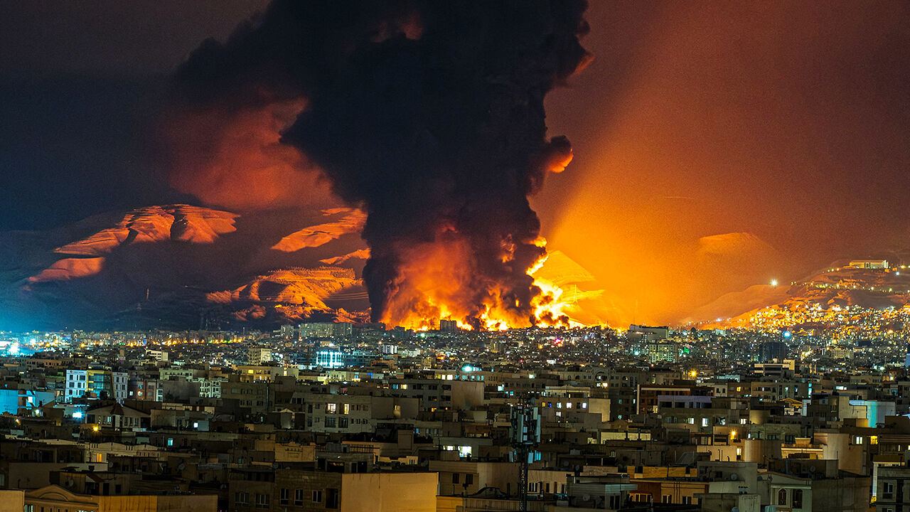 Smoke and flames rise at the site of airstrikes on an oil depot in Tehran.