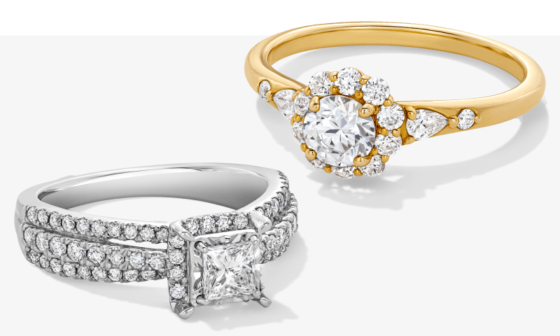 White gold princess-cut diamond ring beside a yellow gold round diamond ring.