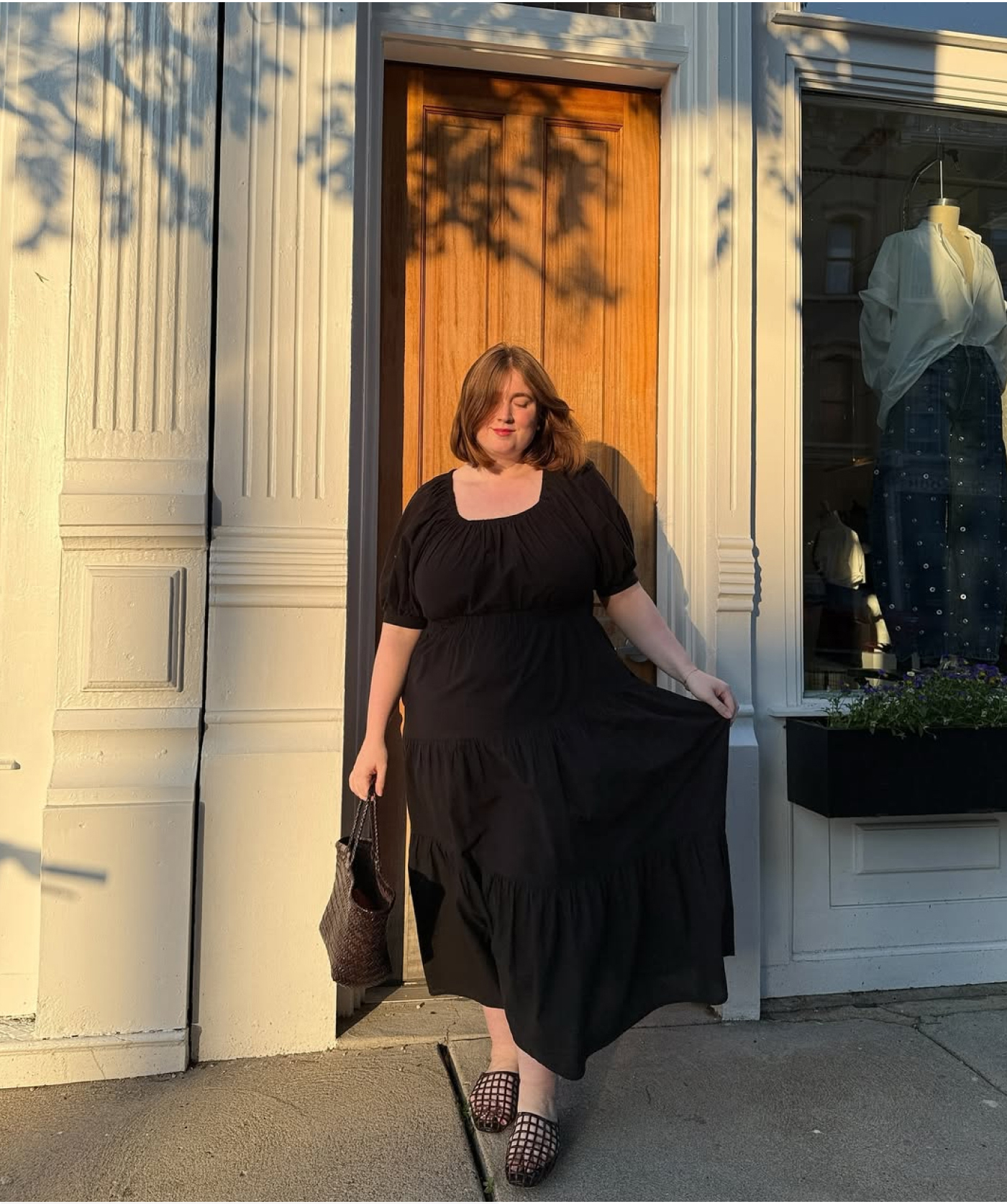@adelialaughs modeling The Bleecker Dress outside a boutique.