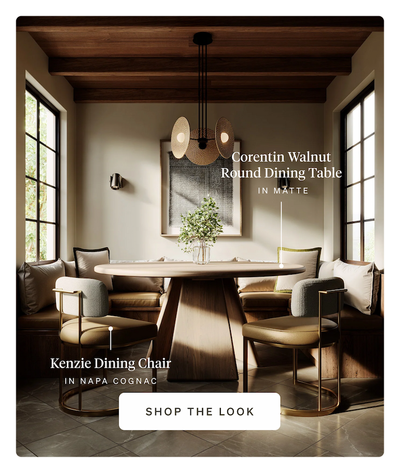 Dining room with a round walnut table and Napa Cognac leather chairs under a unique chandelier.
