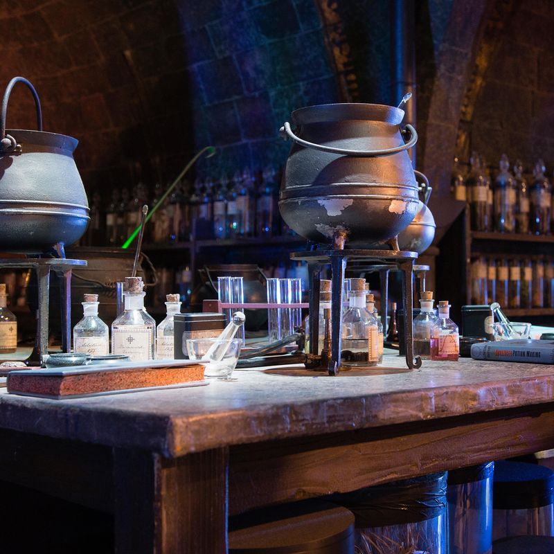 Cauldrons and bottles on a wooden desk
