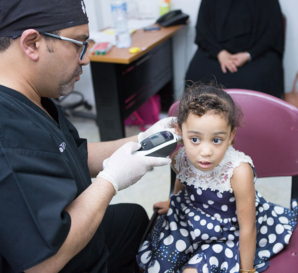Dr. checking a little girl's temperature