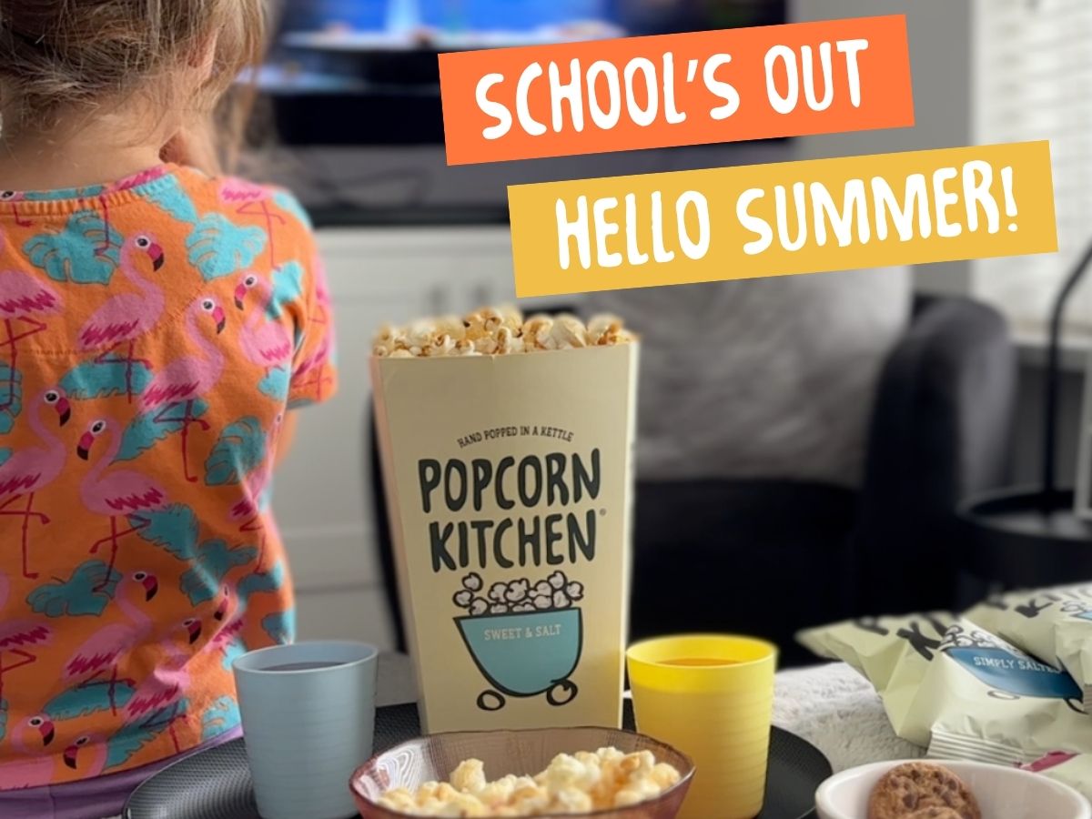 girl watching tv with popcorn