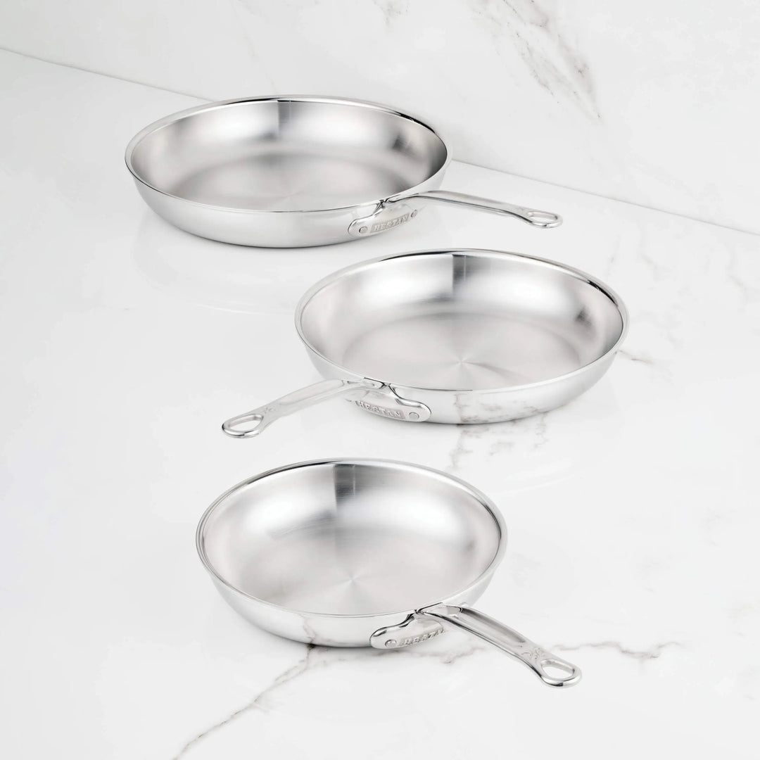IMG: ProBond® Luxe™ Polished Clad Stainless Steel Skillets on marble countertop