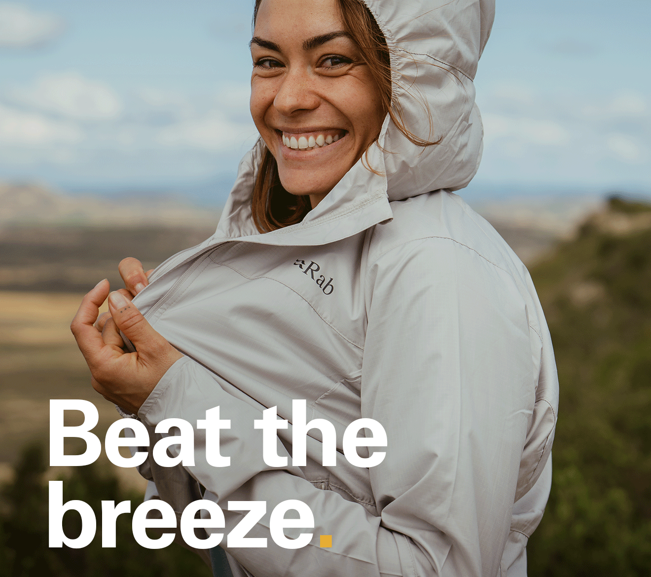 'Beat the breeze' Text over the image of someone wearing a Rab softshell jacket.