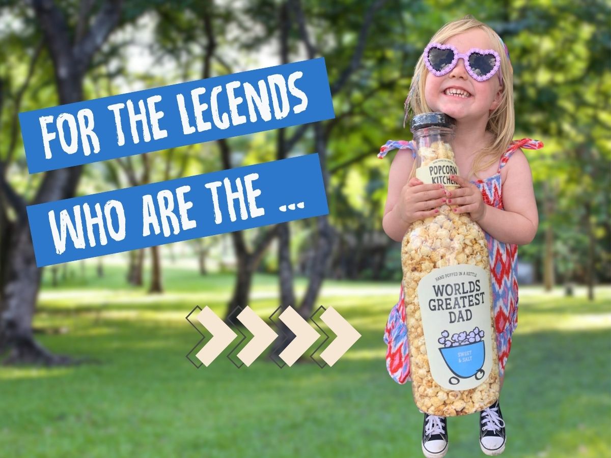 Girls holding giant bottle of popcorn