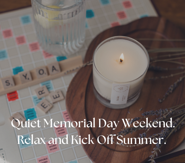 image of the lake candle burning on a wooden board with a game of scrabble next to it