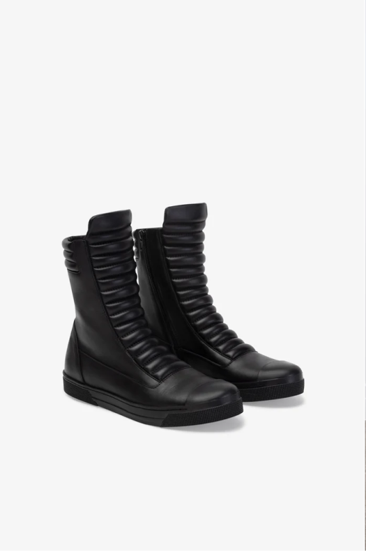 A pair of our black Journey boots on a white background.