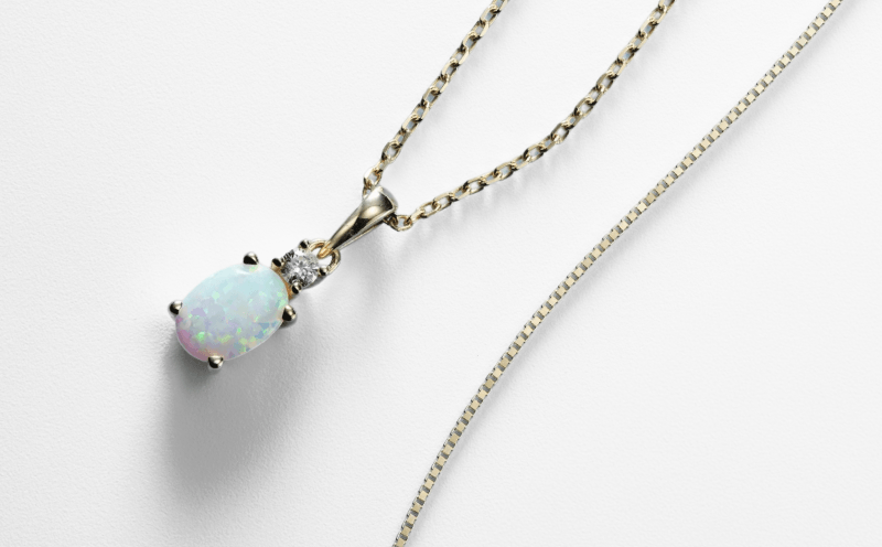 Oval opal pendant necklace with a round diamond accent.