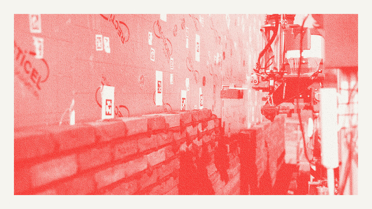 A brick laying robot building a wall. 