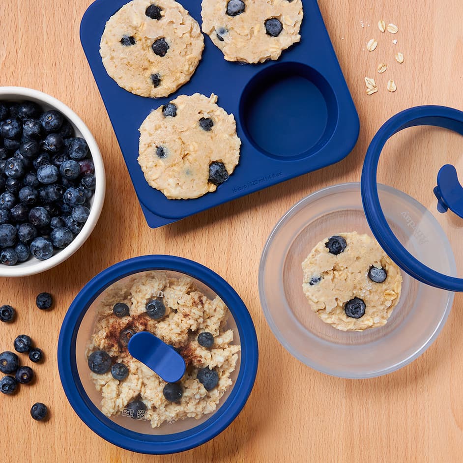 A photo of Blueberry Anytime Freezer Trays with frozen oatmeal, next to Small Dishes with frozen oatmeal and meal prepped cooked oatmeal.