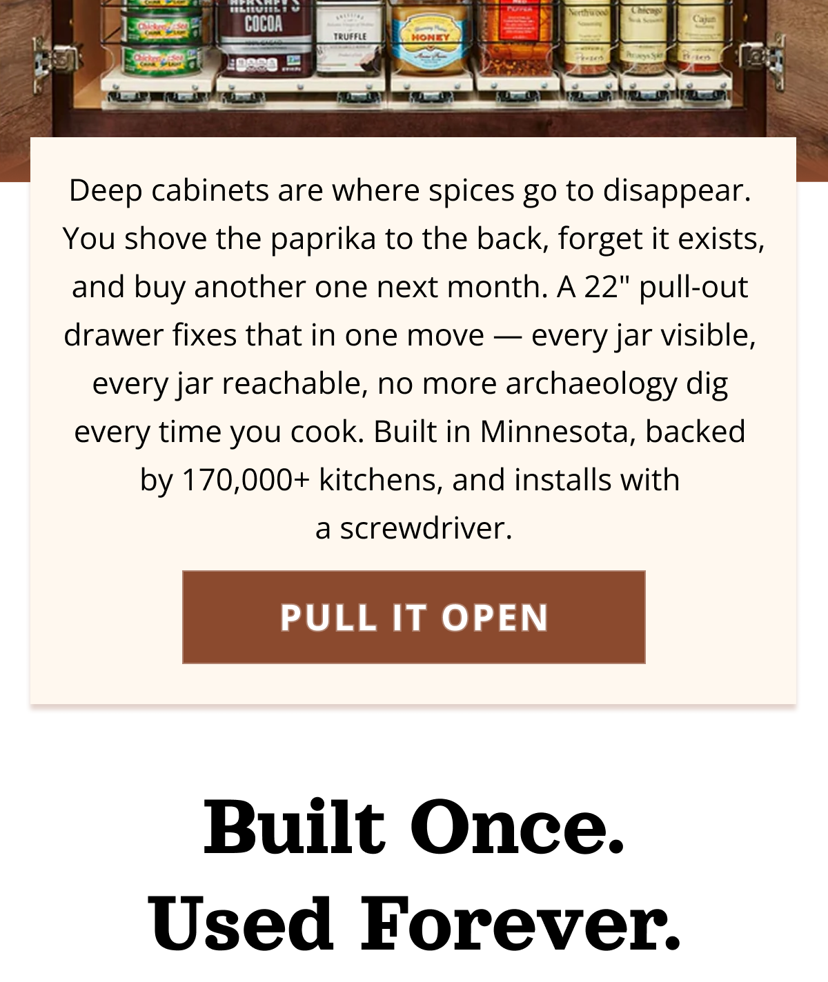 Open kitchen cabinet with pull-out drawers displaying spices clearly and solving deep cabinet storage issues