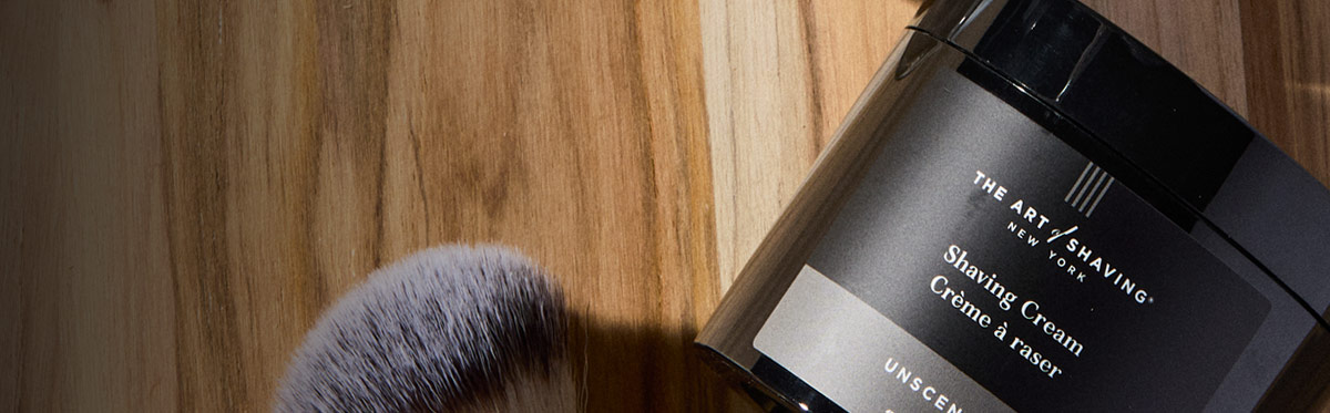 Man admiring shave in mirror post-routine