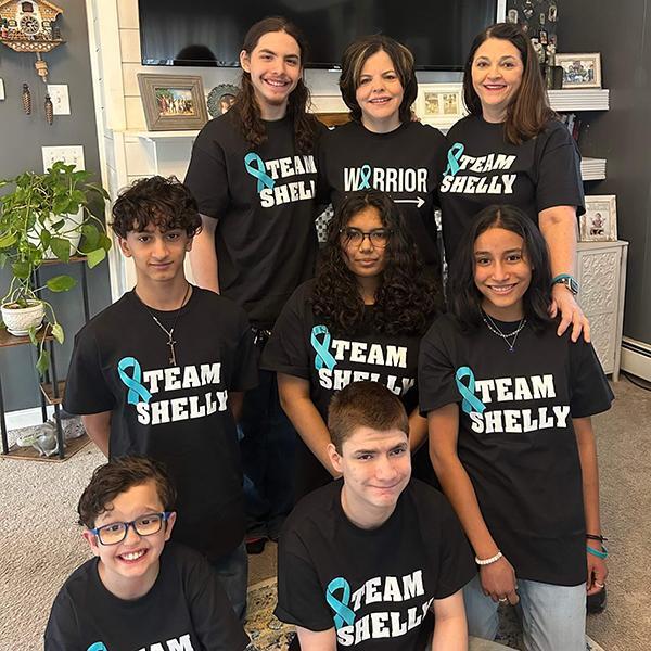 Shelly Sepulveda (center, back row), and her wife, Tami (right), pictured with their children.