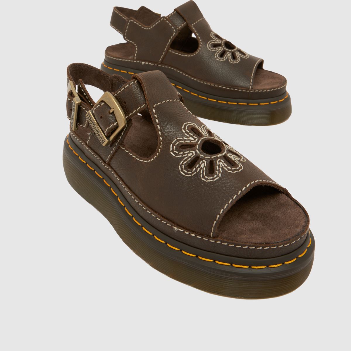 A pair of brown Dr. Martens sandals