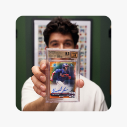 A seller holding a graded Ronald Acuna card.