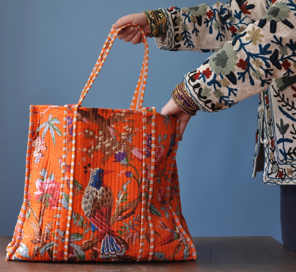 Person holding with one hand inside Ancient India shop bag.