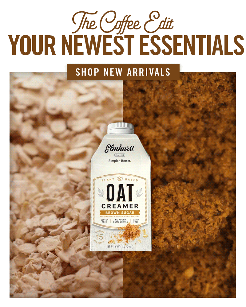 'The Coffee Edit: Your Newest Essentials' featuring a carton of Elmhurst Unsweetened Coconut Barista plant-based milk. The carton is centered against a split background of coconut and a pile of raw cashews, Cashew barista on a background of raw cashews, and Oat Brown Sugar on a split background of oats and brown sugar. Below the product, it reads 'Smooth & Creamy' with a 'Shop New Arrivals' button