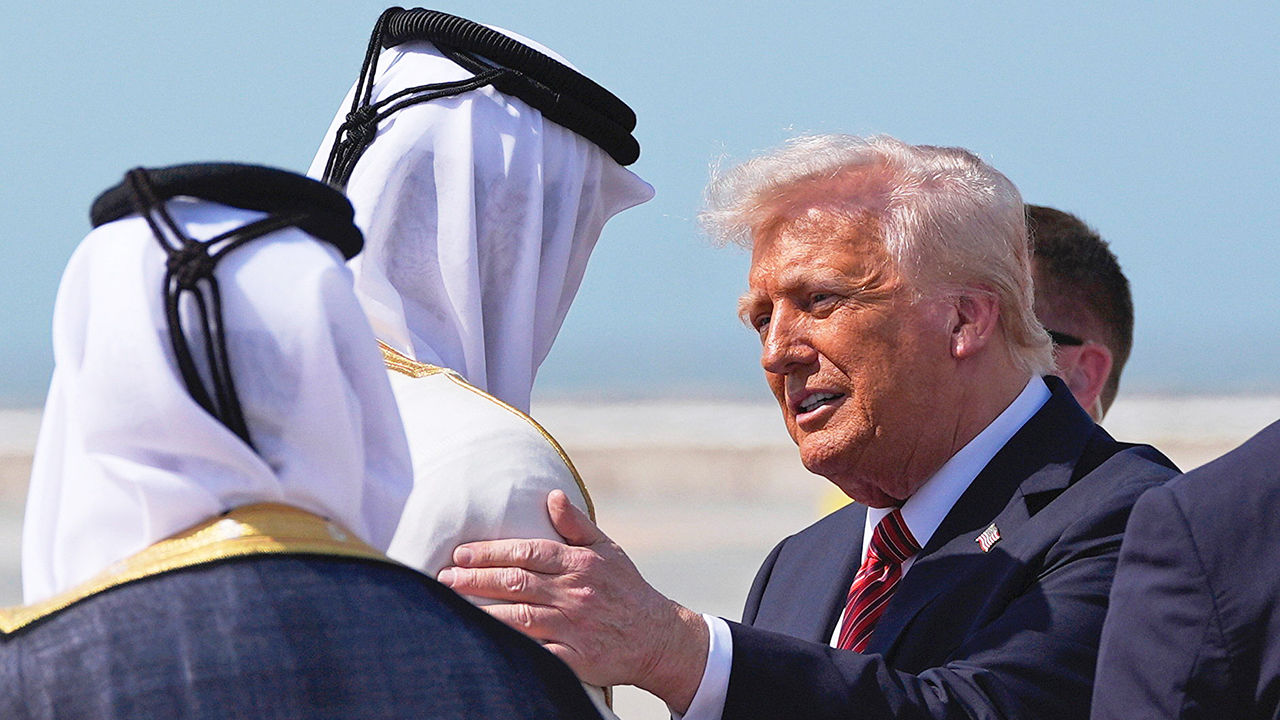 US President Donald Trump is greeted by Qatar's Emir Sheikh Tamim bin Hamad Al Thani at Hamad International Airport in Doha, Qatar, May 14th 2025